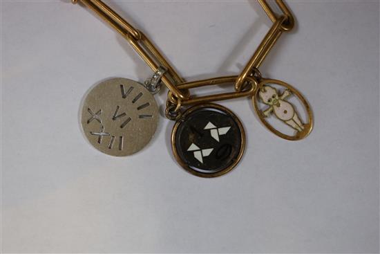 An 18ct bracelet, hung with five assorted charms, gross 33 grams.